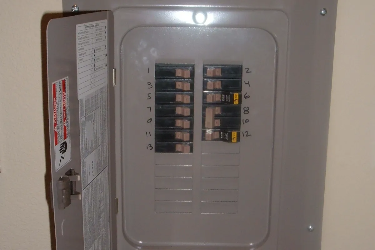 Open circuit breaker panel showing breakers and wiring