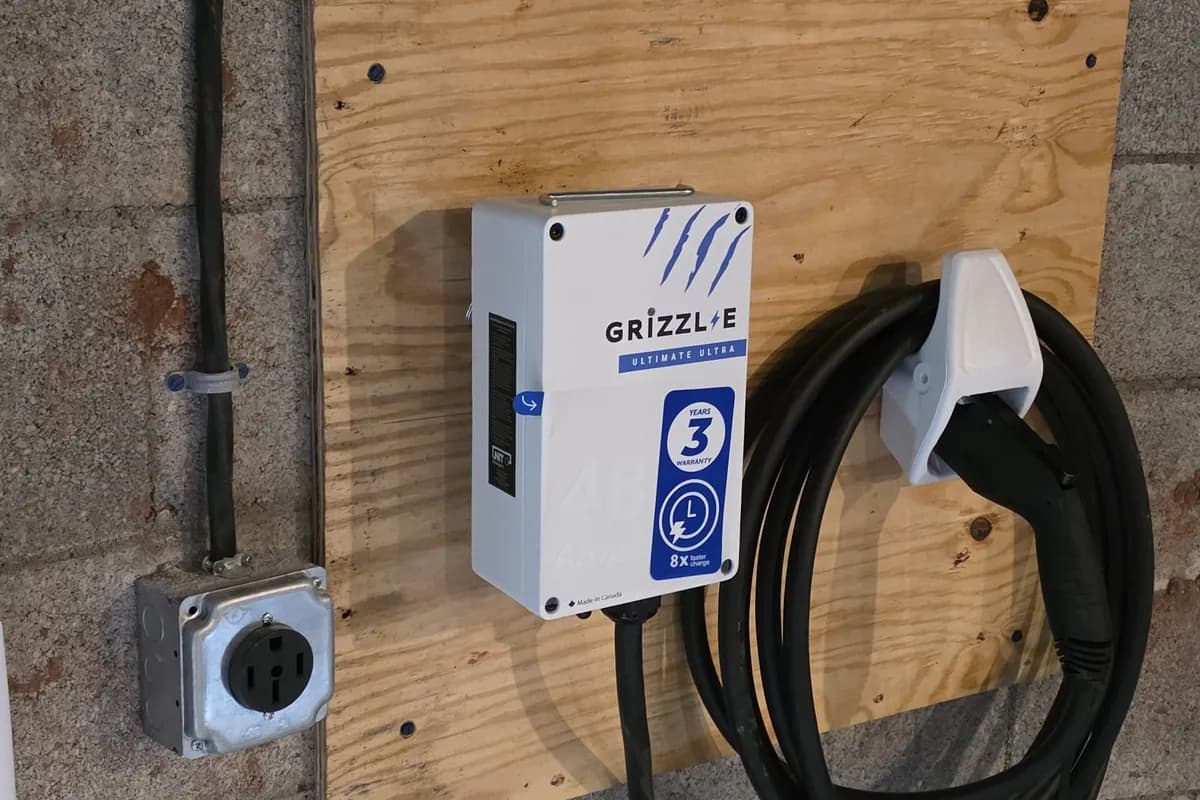 Wall mounted EV charger installed on a block wall