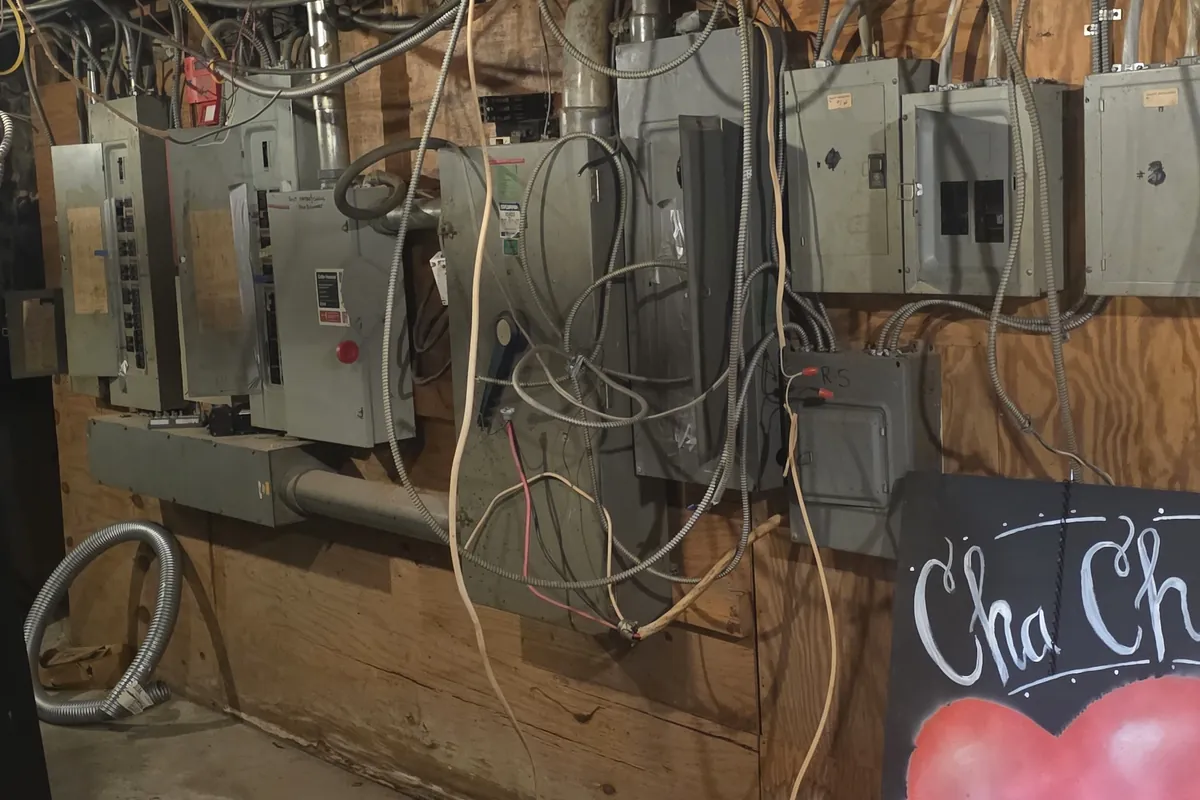 Row of electrical panels along a barn wall