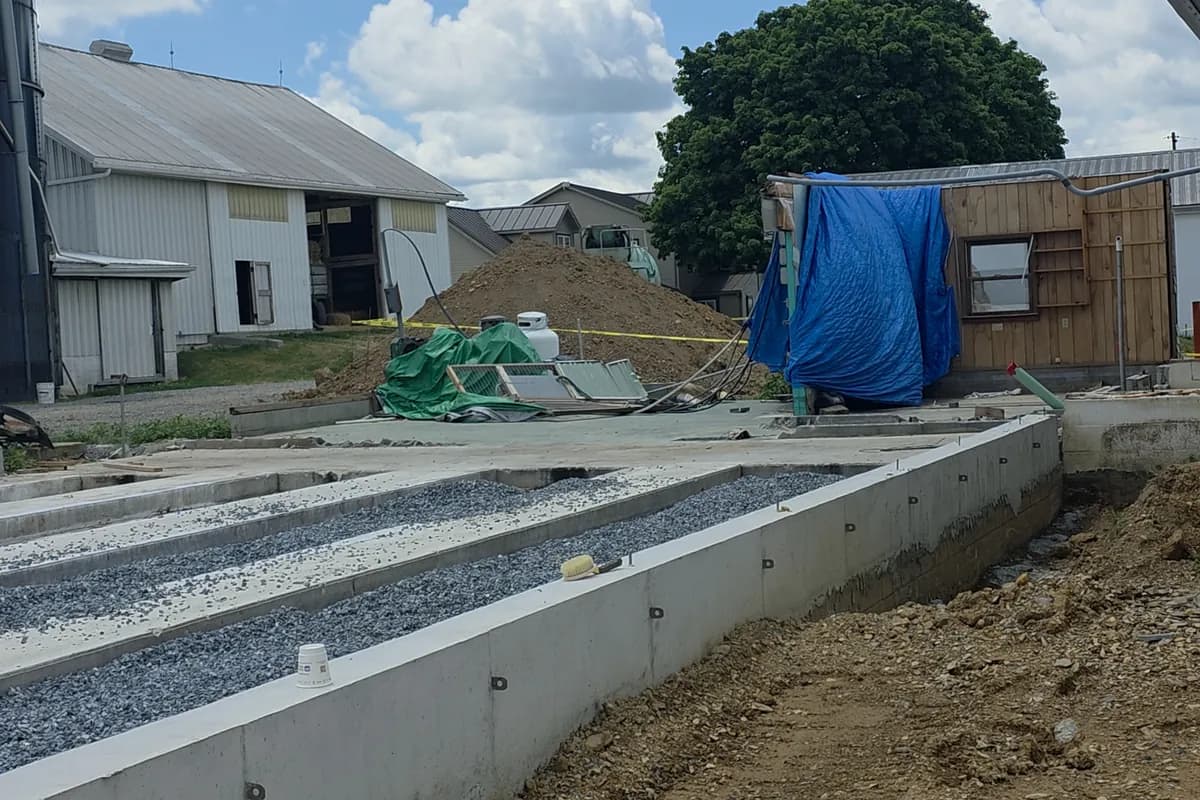 Concrete footing and pad poured for a new farm building