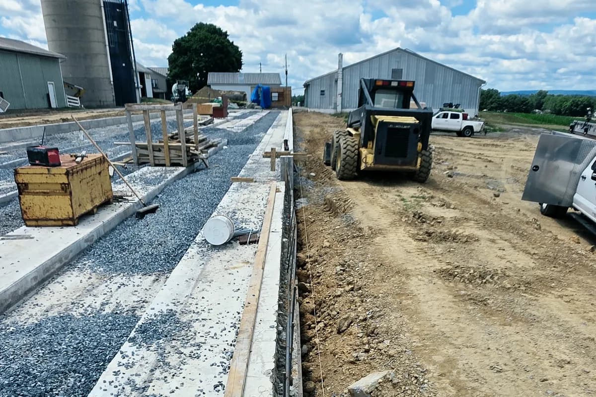 Farm construction site with a silo and machinery