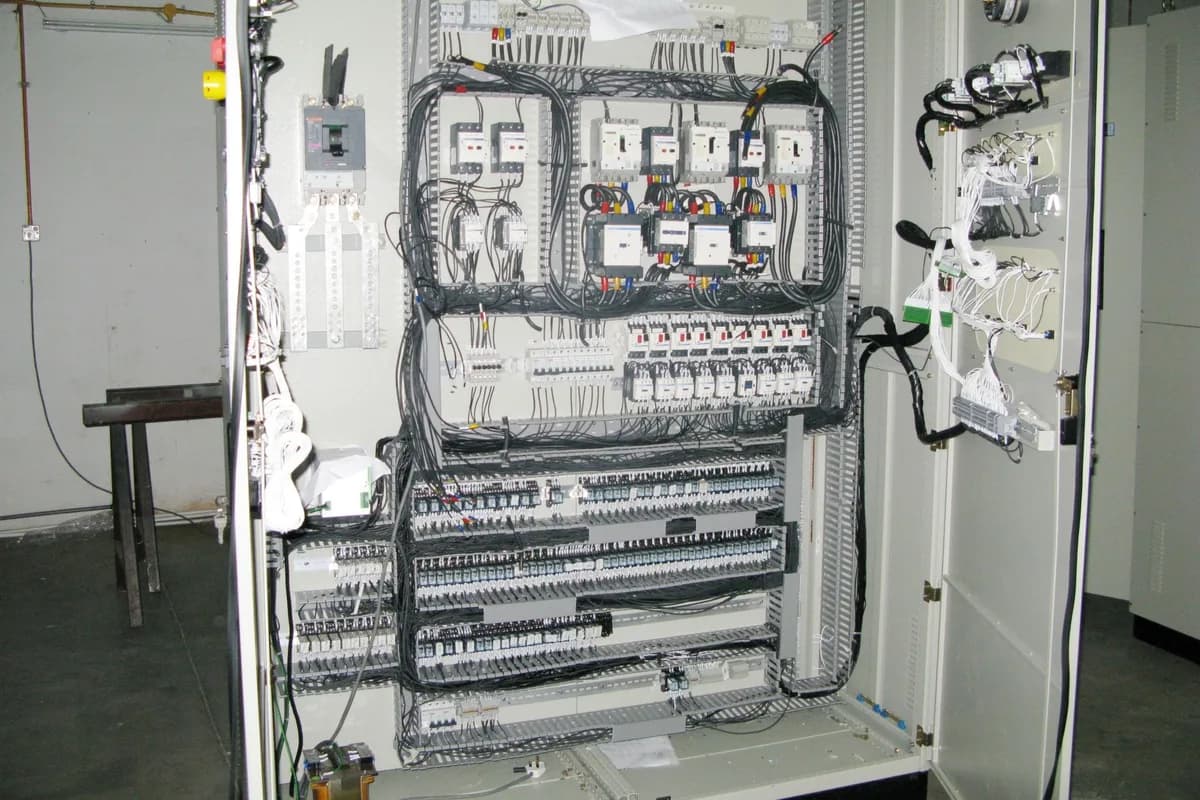 Large open control panel cabinet with contactors, breakers and extensive labeled wiring